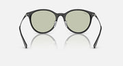 Dark round sunglasses with green-tinted lenses and curved temple arms