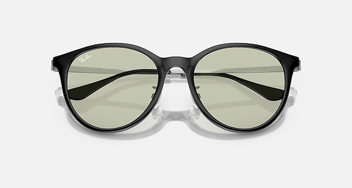 Round sunglasses with dark frame and green-tinted lenses, front view