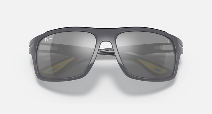Dark gray aviator-style sunglasses with smoky gray mirrored lenses