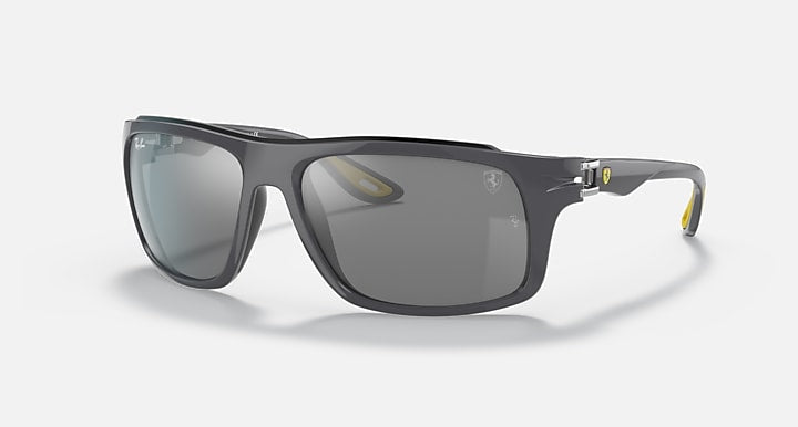 Black aviator-style sunglasses with dark gray lenses and clear side arms