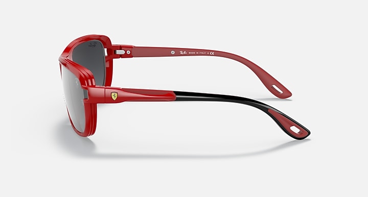 Red aviator sunglasses side view with dark gray lenses and adjustable nose bridge