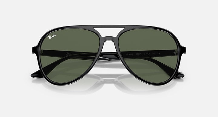 Sunglasses with dark frame and dark green lenses, centered front view