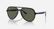 Sunglasses with dark frame and dark green lenses, aviator shape, side angle