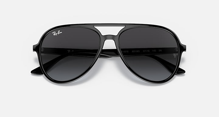 Ray-Ban aviator sunglasses with black frame and dark grey mirrored lenses.