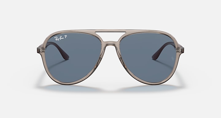 Ray-Ban aviator sunglasses with opal-look frame and blue-tinted lenses.