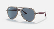 Ray-Ban aviator sunglasses with clear silver frame and blue-tinted lenses.