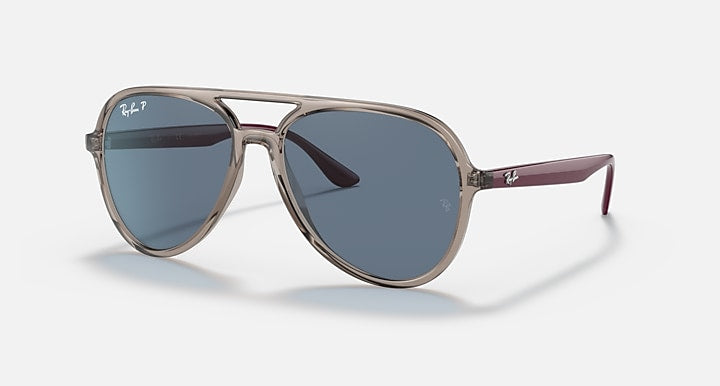 Ray-Ban aviator sunglasses with clear silver frame and blue-tinted lenses.