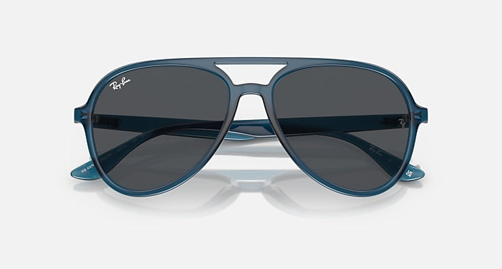 Ray-Ban aviator sunglasses with dark gray lenses and blue frame, wide front angle.