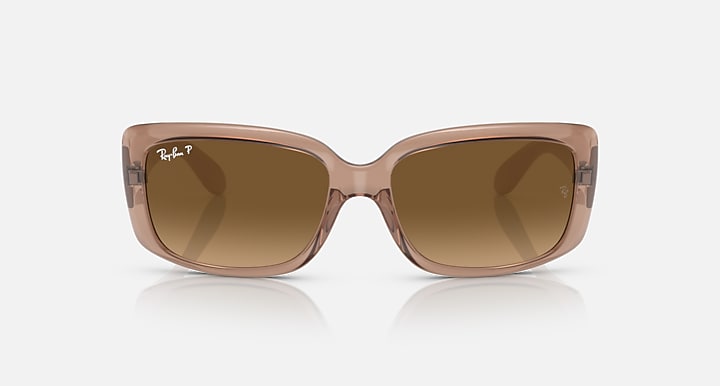Ray-Ban sunglasses with translucent brown frames and brown tint lenses.