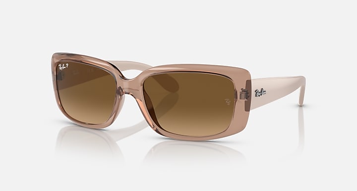 Ray-Ban sunglasses with translucent brown frames and brown gradient lenses.