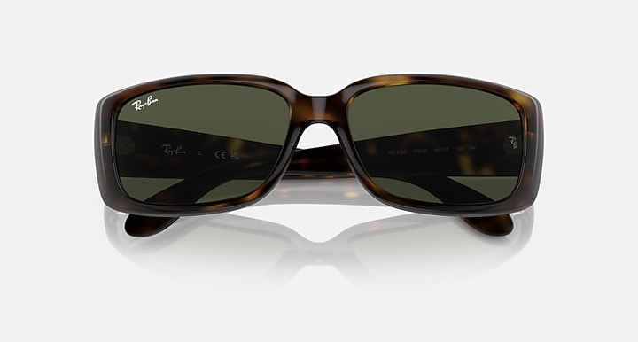 Havana brown sunglasses with dark green lenses, slight angle