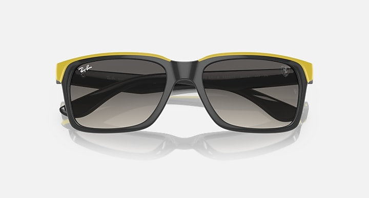 Ray-Ban RB4393M sunglasses, black with yellow rubber trim and dark grey gradient lenses