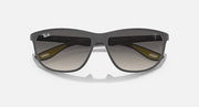 Ray-Ban RB4394M sunglasses, dark frame with mirrored lenses and yellow accents