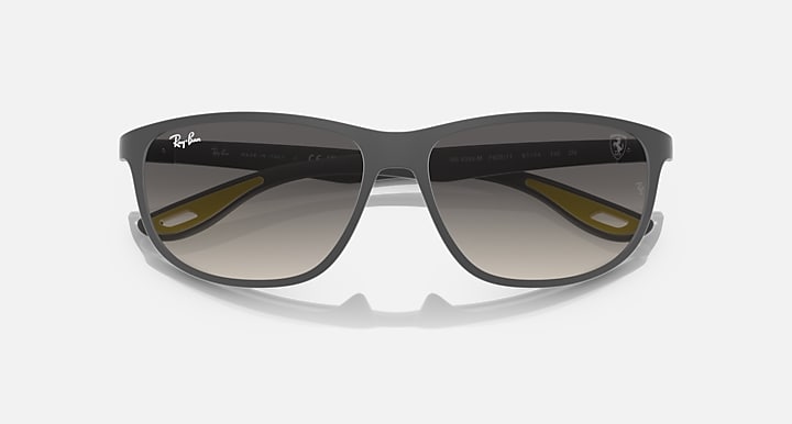 Ray-Ban RB4394M sunglasses, dark frame with mirrored lenses and yellow accents