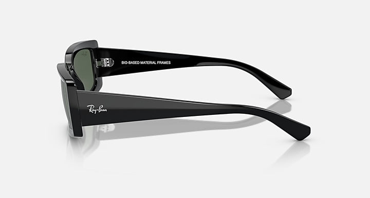 Black sunglasses side view with dark green lenses and slim metal temple