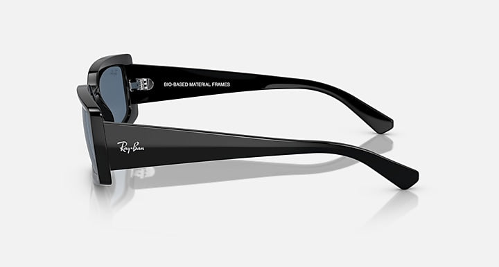 Black sunglasses with dark lenses, side view and logo on temple
