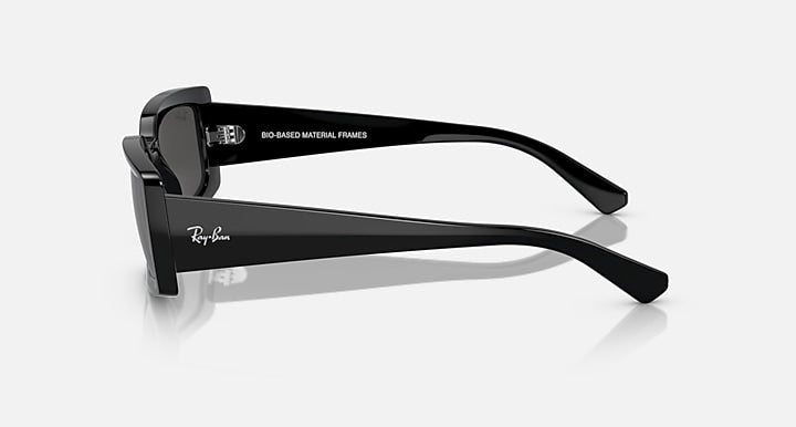 Black sunglasses with dark lenses, side view with Ray-Ban logo