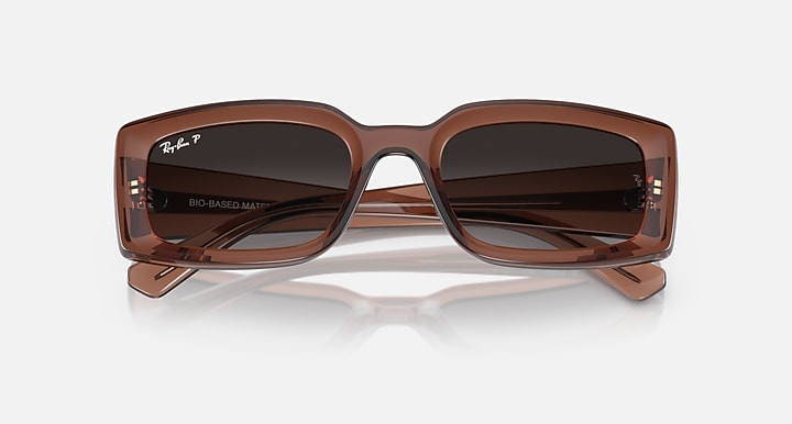 Brown sunglasses with dark brown lenses and glossy wraparound front