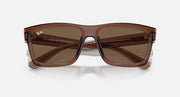 Transparent brown sunglasses with brown tinted lenses and top branding on frame.