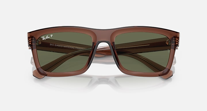 Transparent brown sunglasses with dark green lenses and Bio-based markings, front