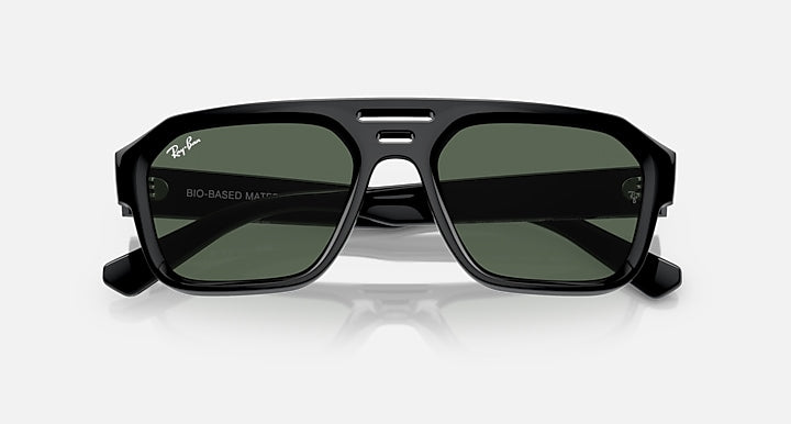 Rectangular sunglasses with black frame and green tinted lenses, front close-up