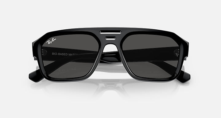 Rectangular sunglasses with black frame and dark tinted lenses, bridge detail