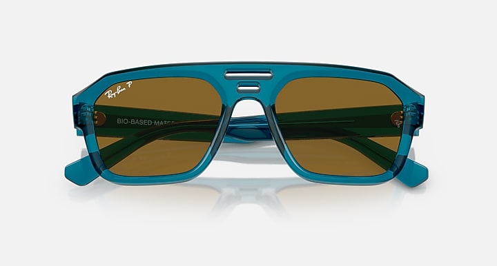 Blue-green sunglasses with brown lenses and wide frame front