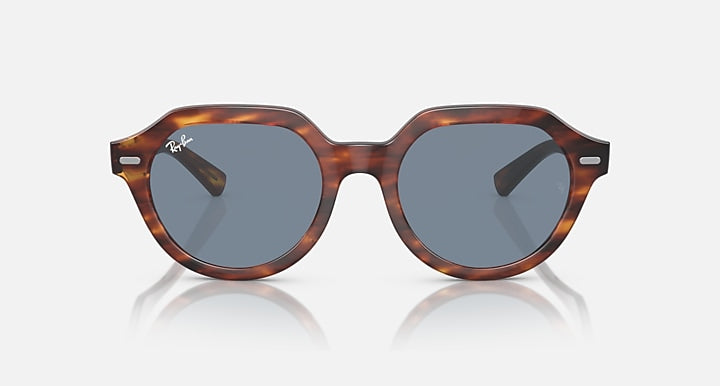 Ray-Ban Gina round sunglasses with tortoiseshell brown frames and blue-gray lenses, angled