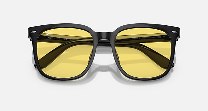 Black sunglasses with yellow mirrored lenses and angular reflections