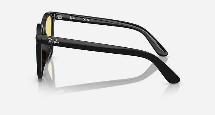 Black sunglasses side profile with clear lens rim and curved temple
