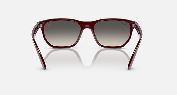 Ray-Ban RB4404M sunglasses, front view with dark red frames and grey gradient lenses