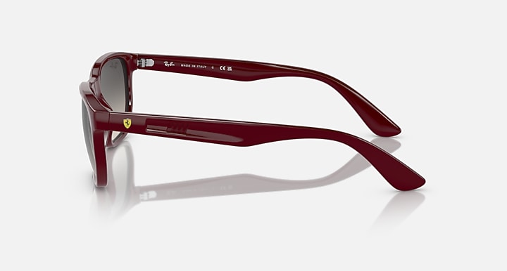 Ray-Ban RB4404M sunglasses, side view of dark red frames with grey gradient lenses