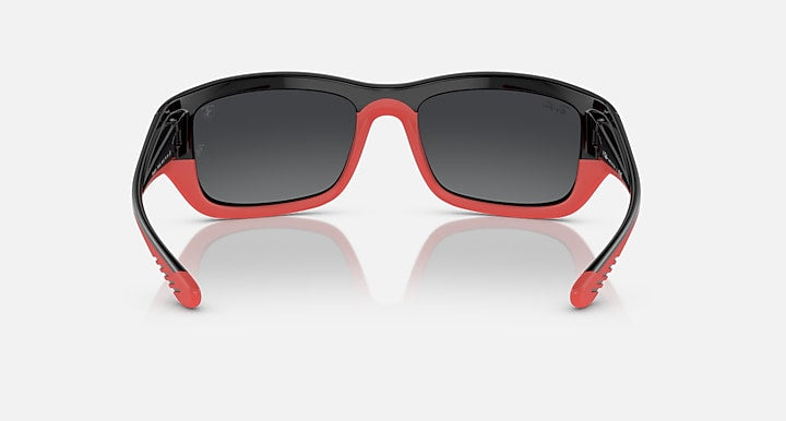 Red-accent sunglasses with dark lenses and black frame, front view