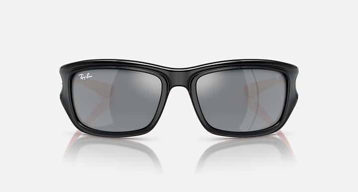 Black sunglasses with dark grey lenses, squared frames, and low-profile nose bridge