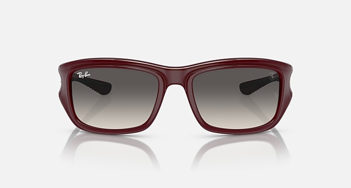 Dark red sunglasses with grey tinted lenses and low-profile rectangular frames