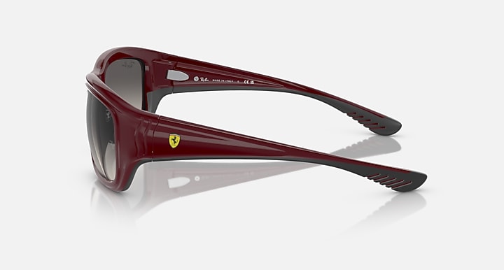 Dark red sunglasses with side temple view, black inner details, and tinted lenses