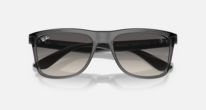 Overhead/front dark gray wayfarer sunglasses with gradient smoke lenses and frame cutouts.