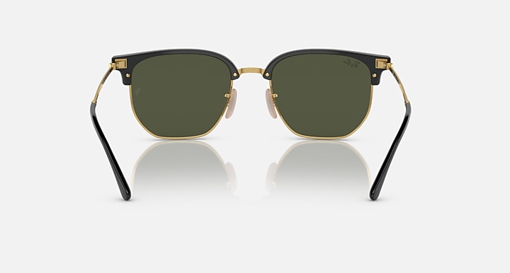 Ray-Ban Clubmaster sunglasses front view with black frames, gold rims, dark green lenses