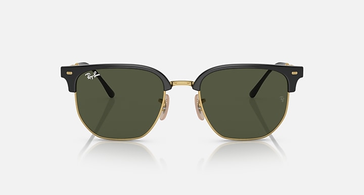 Ray-Ban Clubmaster sunglasses front view with black frames, gold bridge, dark green lenses