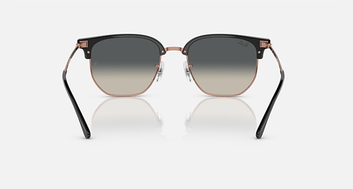Clubmaster sunglasses front view, dark gray lenses and black frame with rose-gold details