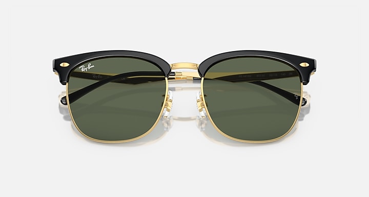Ray-Ban RB4418D sunglasses, close front, dark green lenses, black frames with gold hardware