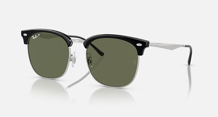 Ray-Ban RB4418D sunglasses, angled view, dark green polarized lenses, black frames with silver arms