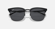 Ray-Ban RB4418D round sunglasses with black frame and dark gray lenses, close front