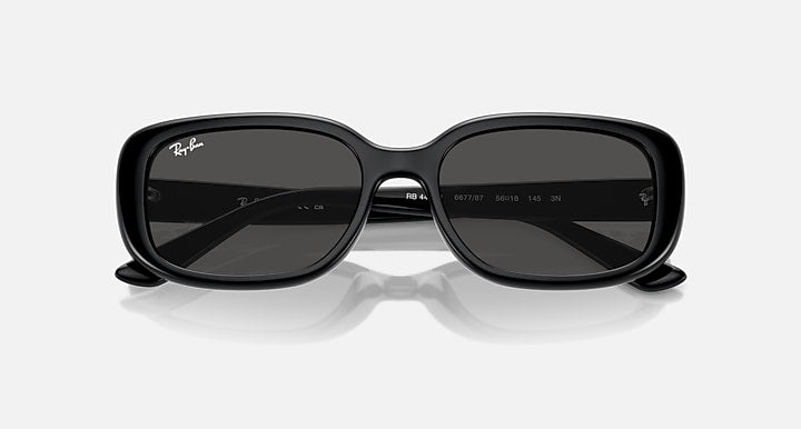 Black Ray-Ban sunglasses with dark wrap lenses and centered bridge detail