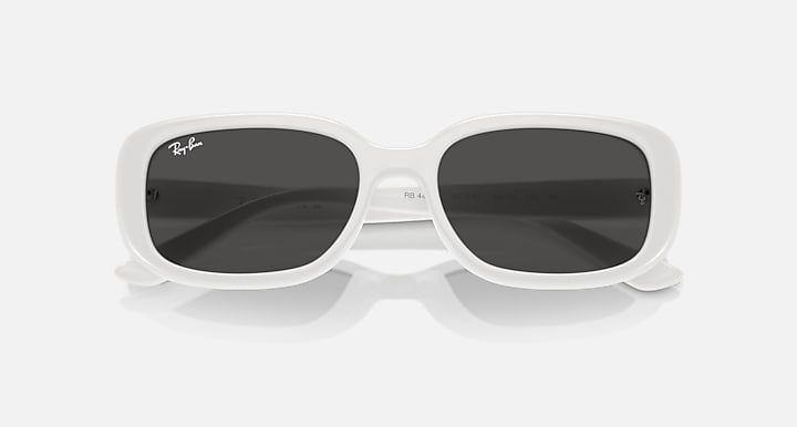 White Ray-Ban RB4421D sunglasses angled view with dark grey lenses and wide bridge.