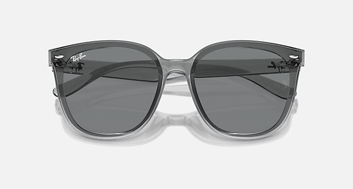 Sunglasses with clear gray frames and dark tinted lenses, front view
