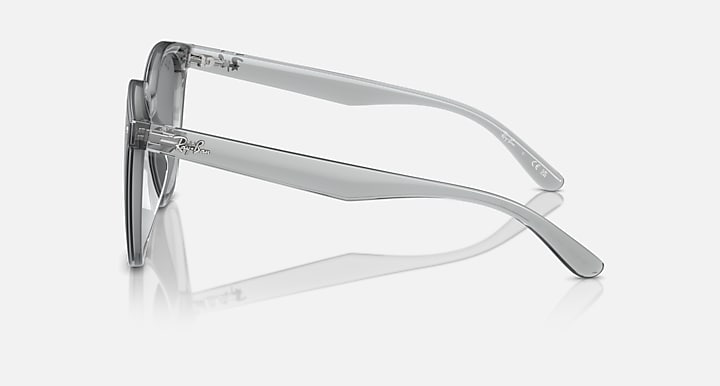 Sunglasses, clear gray frame side profile with dark lens and curved temple