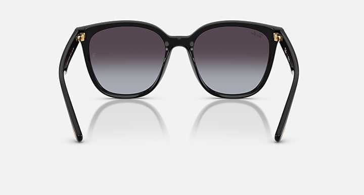 Front view of black sunglasses with dark purple lenses and gold-trimmed corner tips.