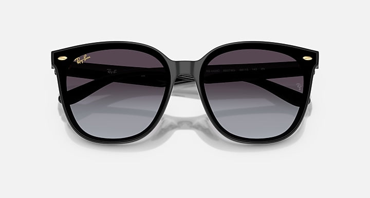 Black sunglasses with dark purple lenses and slightly oversized square shape.