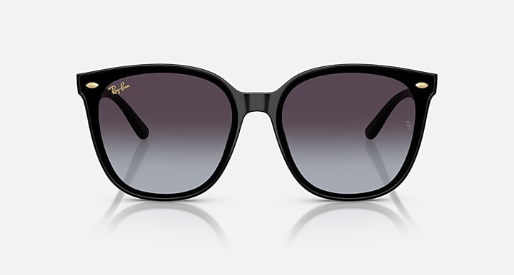 Black sunglasses with wide square lenses and dark purple tint; gold accents on hinges.
